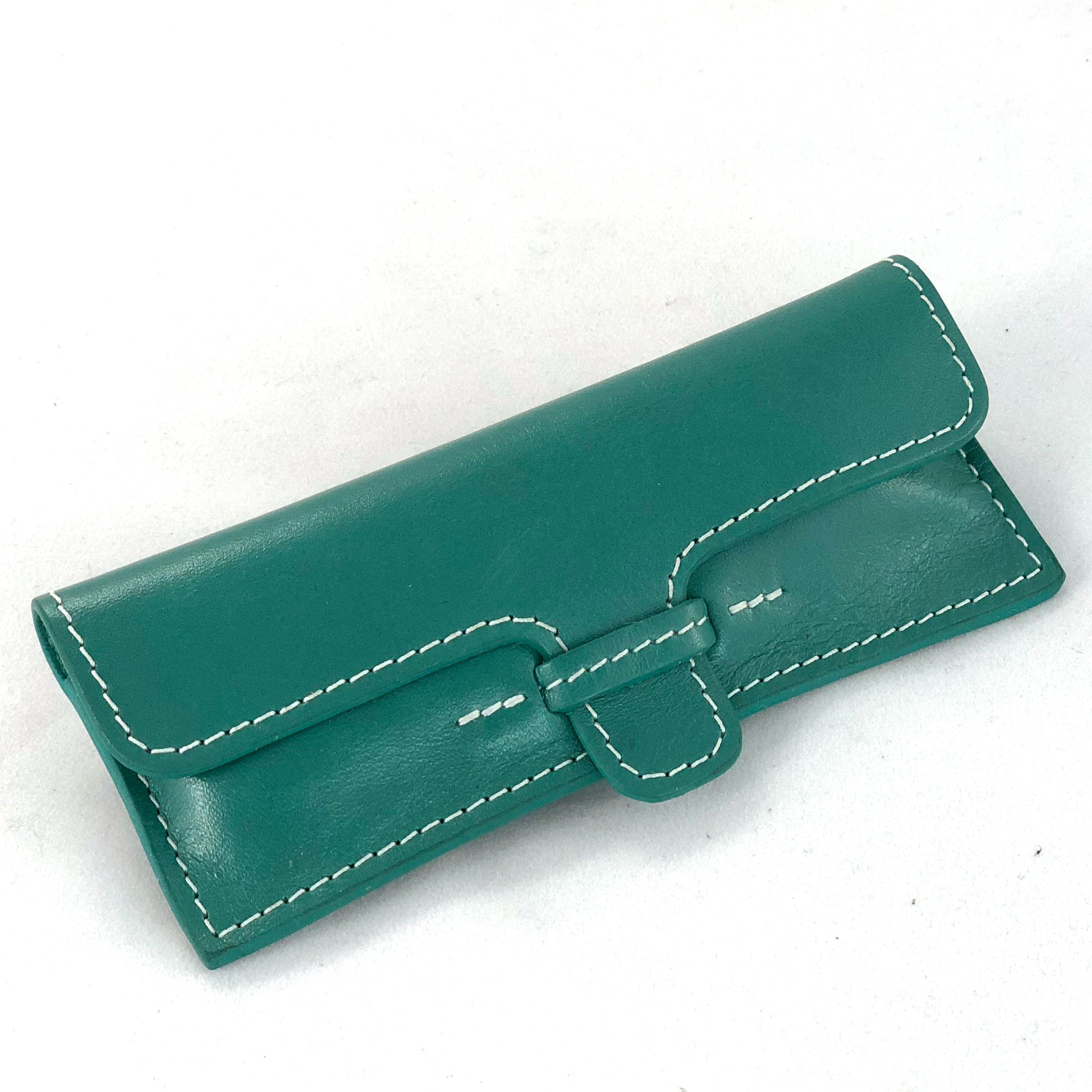 Leather case for stainless steel corkscrew, shown closed from front.