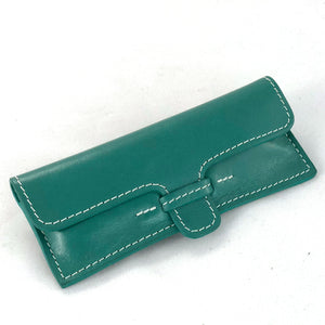 Leather case for stainless steel corkscrew, shown closed from front.