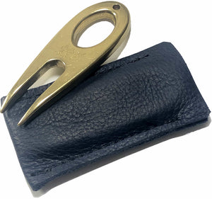 Golf divot tool solid brass with aniline leather sleeve, showing the color.