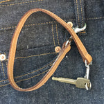 Load image into Gallery viewer, Leather key lanyard in saddle tan attached to Levis belt loop
